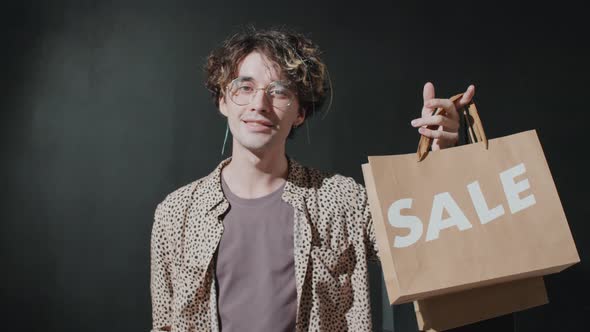 Portrait of Young Handsome Man with Sale Shopping Bag
