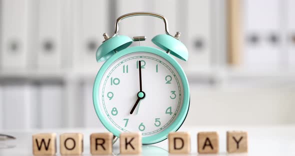 Text Working Day and Alarm Clock on Table in Office