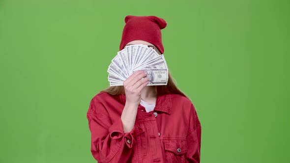 Girl Is Holding Paper Money in Her Hands. Green Screen. Slow Motion