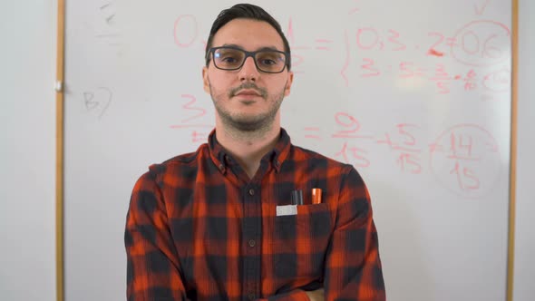 Portrait of European Young Teacher in Font of Writing Board