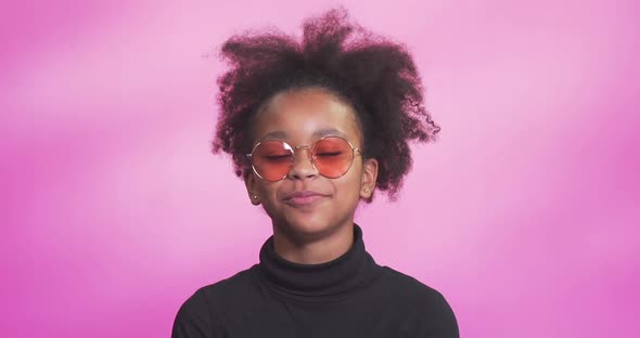 Portrait of a Beautiful African Girl on a Pink Background Girl Video Blogger Talking Laughs and