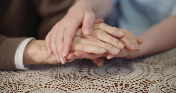 Woman Comforting Wrinkled Old Hand