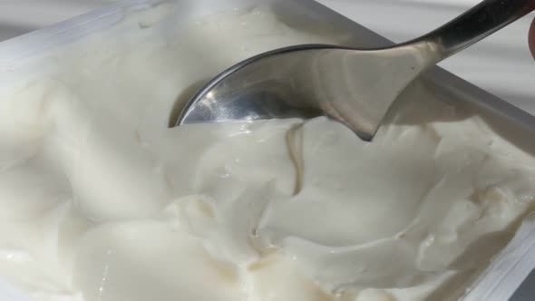 Close-up taking with creme cheese metallic spoon 4K footage