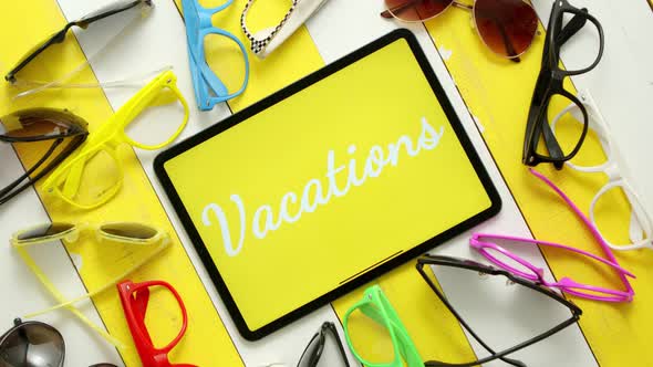 Various Style, Shape and Colour Sunglasses, Tablet in the Middle with Text VACATIONS