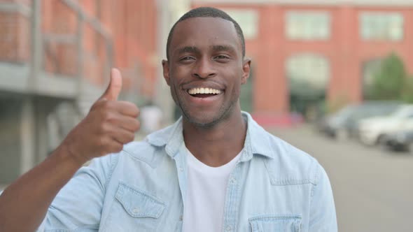 Portrait of African Man Showing Thumbs Up Sign Outdoor