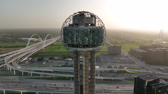 Reunion Tower and bridges over Trinity River. Aerial orbit during sunset reveals Downtown Dallas Tex