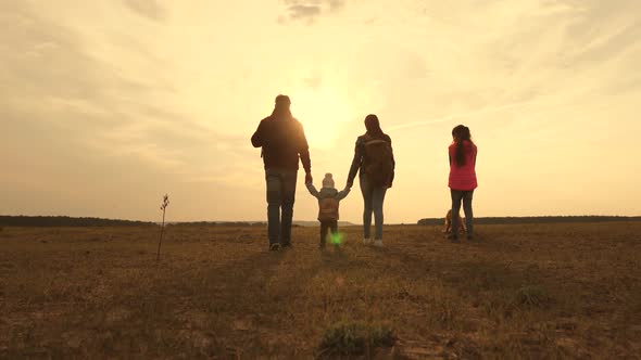 Dad, Mom, a Small Child and Daughters and Pets Tourists. Teamwork of a Close-knit Family