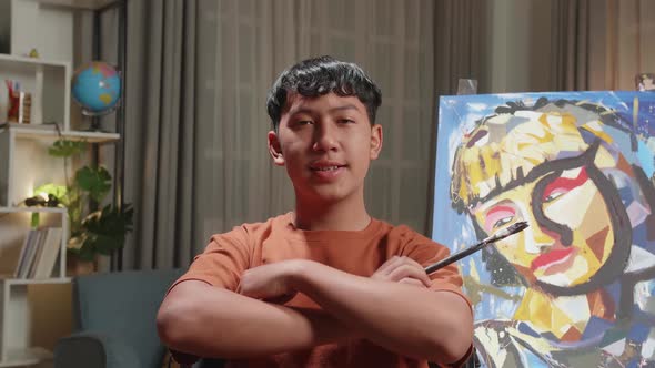 Asian Artist Boy In Wheelchair Holding Paintbrush And Cross His Arms And Smile To Camera