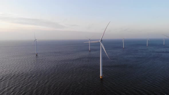 Offshore Windmill Park with Clouds and a Blue Sky Windmill Park in the Ocean Drone Aerial View with