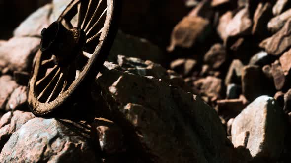 Old Wooden Wheel on Rocks