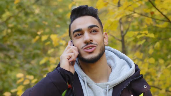 Closeup Happy Young Handsome Arab Man Standing Outdoor Tourist Travels in Nature Smiling Talking on