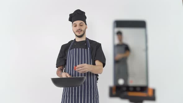 Professional Male Chef Doing Online Cooking Lesson Filming Him with Smartphone