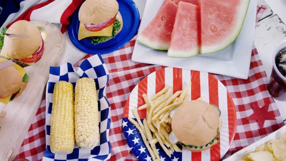 Hamburgers and french fries served on table with 4th july theme