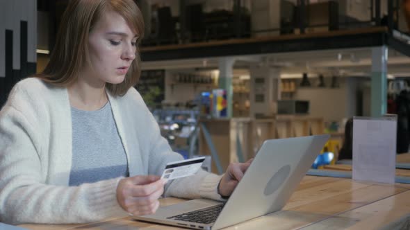 Online Shopping by Young Woman in Cafe, Credit Card