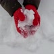 Young Woman in Winter Knitted Woolen Mittens Sculpts a Heart Out of Snow - VideoHive Item for Sale