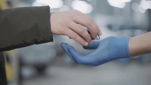 Unrecognizable Client Passing Car Keys To Auto Mechanic Indoors