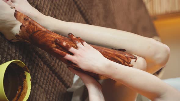 Woman Gets a Massage at the Spa with Liquid Chocolate