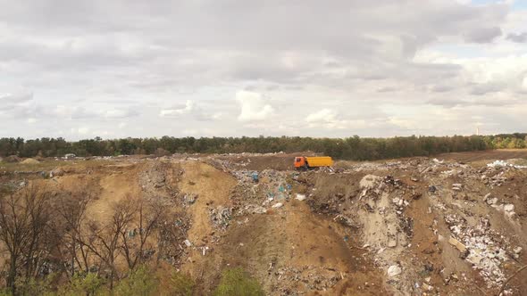 Trucks Bring Waste To a Garbage Pile in Trash Dump. Aerial View of Large Garbage Pile at Sorting