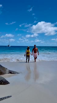 Anse Georgette Praslin Seychelles Young Couple Men and Woman on a Tropical Beach During a Luxury