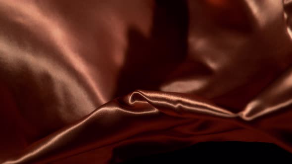 Bronze Wavy Fabric Background in Super Slow Motion