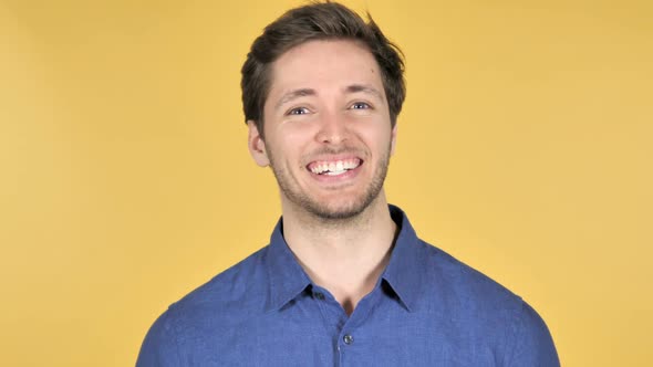 Yes Admiring Casual Young Man on Yellow Background