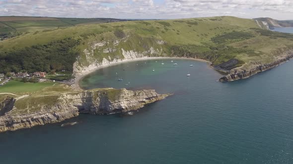 Cornwall aerial drone view of seaside rocky cliffs and turquoise water