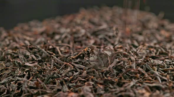 Spinning and Falling Dry Black Tea Closeup Background