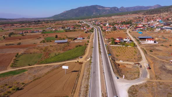 Aerial View of Picturesque Rural Scenery with Houses and Country Road