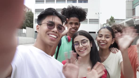 Asian Young Guy and Group of Multi Ethnic Teenager Friends Taking Selfie Photo with Phone Looking