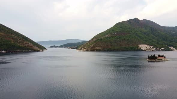 Cozy Bay with Little Island Among Mountains