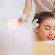 Asian beautiful woman enjoy thai hot compress massage with herbal bags. - VideoHive Item for Sale
