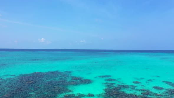 Aerial drone shot texture of exotic seashore beach vacation by shallow ocean and white sandy backgro