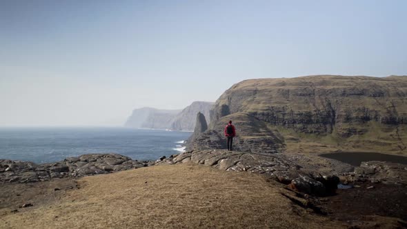 Man Looking At Sea And Dramatic Landscape