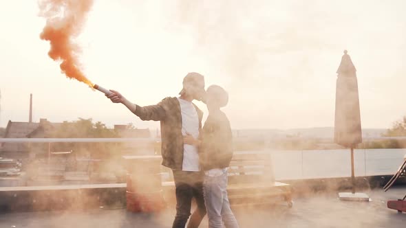 Young Man Kisses his Girlfriend Romantically on the Terrace