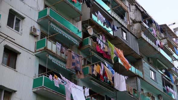 Clothes Hanging and Drying on a Rope on a Multi-story Building in a Poor District of the City