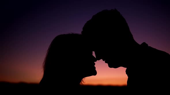 Silhouettes of Man and Woman in Love Looking at Each Other