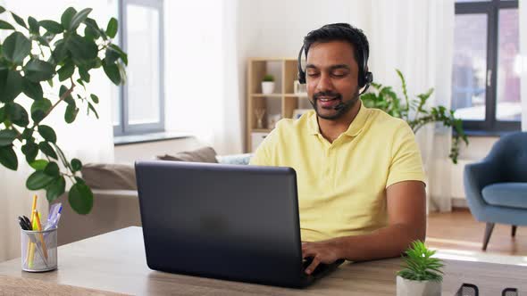 Indian Man with Headset and Laptop Working at Home