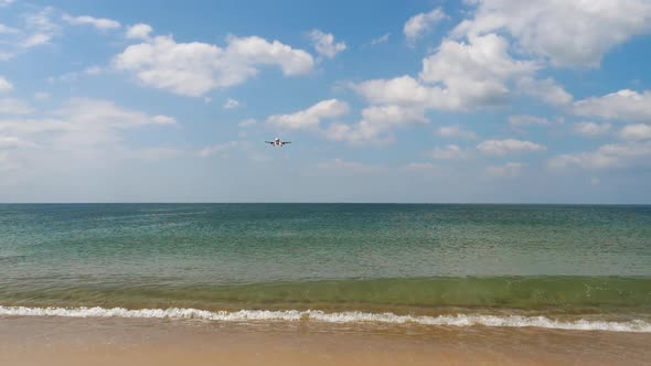 Airliner Approaching Over Oceanic Beach
