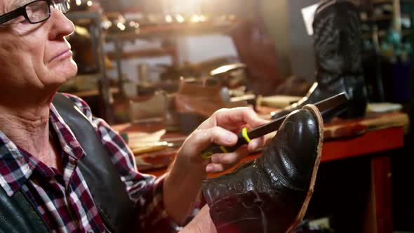 Shoemaker repairing a shoe