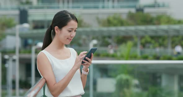 Woman use of cellphone at business district