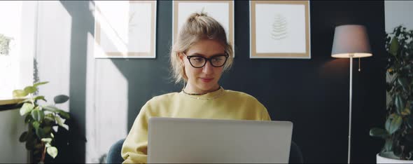 Woman Working on Laptop at Home