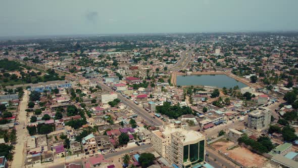 Cinematic Circular Motion Aerial View of African City traffic, showing water retention, Lomé, West A