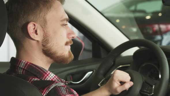 Close Up of a Happy Handsome Male Car Ownes Smiling with Car Keys in His Hand