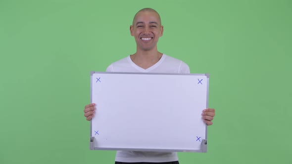 Happy Handsome Bald Man Talking While Holding White Board