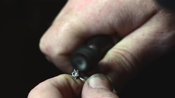 Closeup of Wedding Ring Polishing By Caicasian Jeweler Isolated  Footage