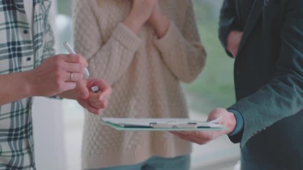 Couple signing on contract paper