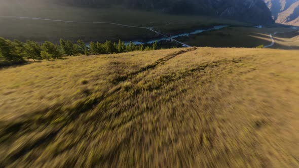 FPV Sports Drone Shot Flight Dry Yellow Grass Field Hilly Terrain Sunny Landscape