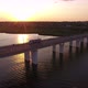 Aerial Shot of a Big Bridge with a Riding Semi-trailer at Golden Sunset in Summer - VideoHive Item for Sale