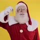 Santa Claus holding keys of new house or apartment on yellow background - VideoHive Item for Sale