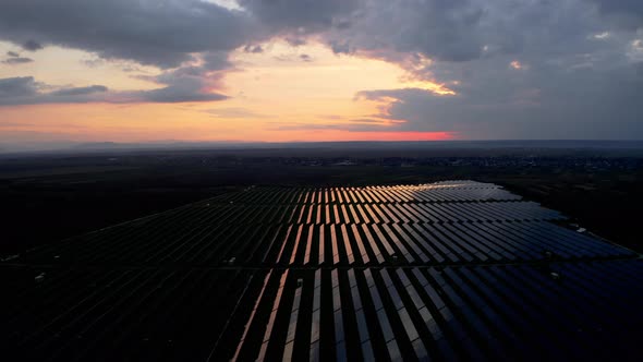 Drone fly over Solar Power Station at Dusk. Top aerial view of Solar Panels.